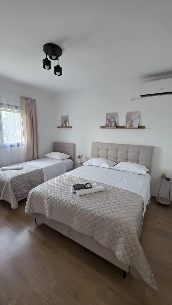 MareVista bedroom 2 with double bed and single bed in Kučine holiday home