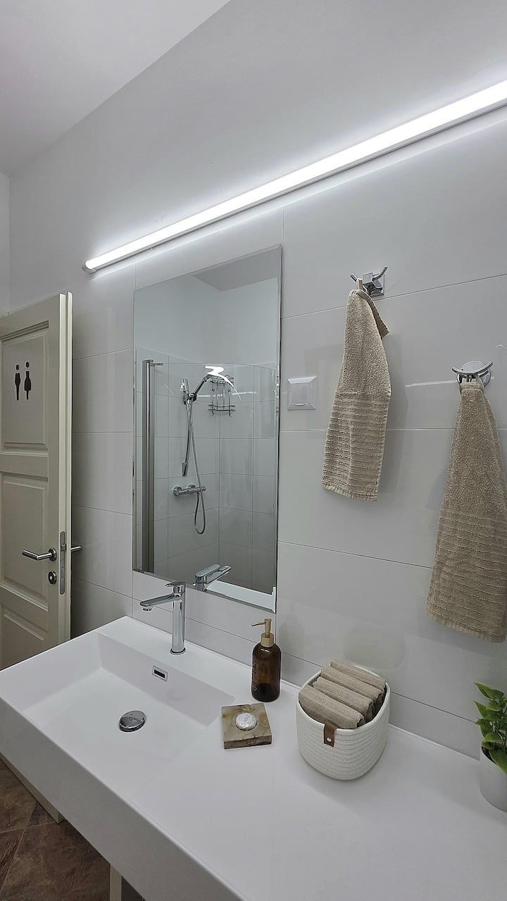 MareVista white bathroom with modern walk-in shower